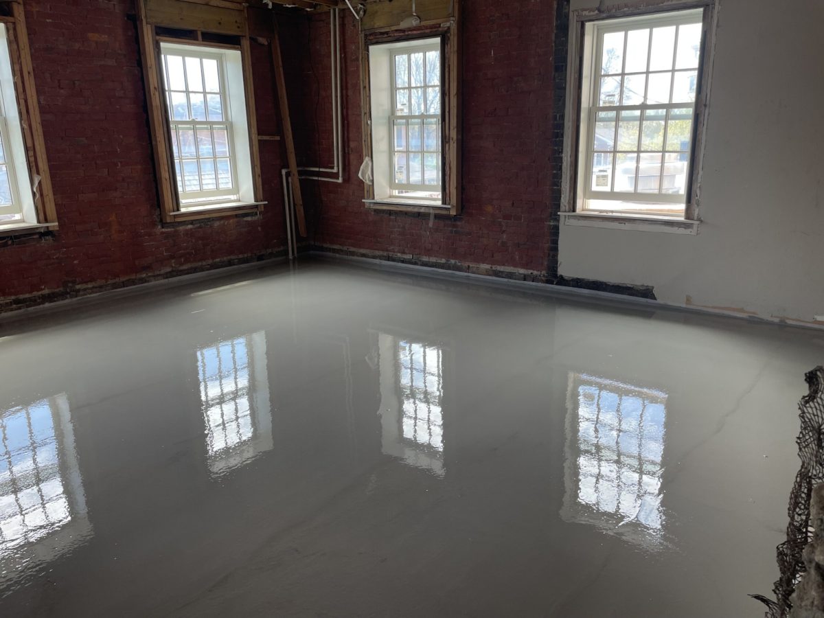 Poured underlayment in a renovated building